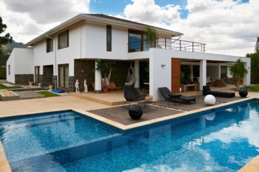 Geometric pool design using brick with gazebo & decorative lighting